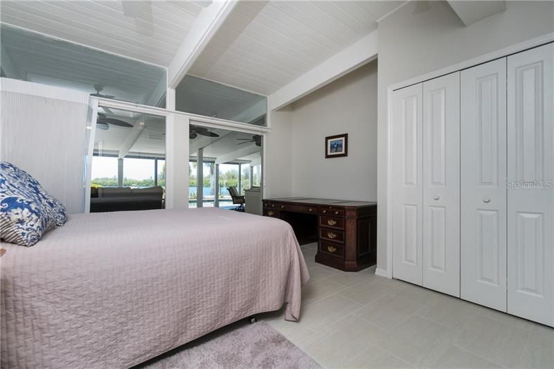 Bedroom #4 features sliding glass doors to the lanai.