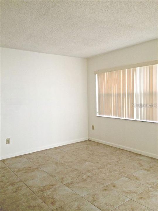 Master Bedroom with large window and tile floor