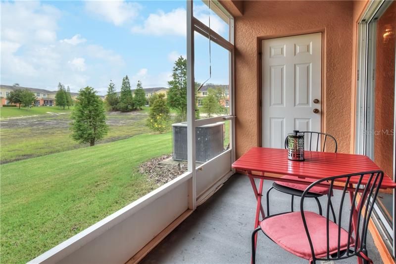 Screened-in lanai with view of retention pond that fills up in the summer