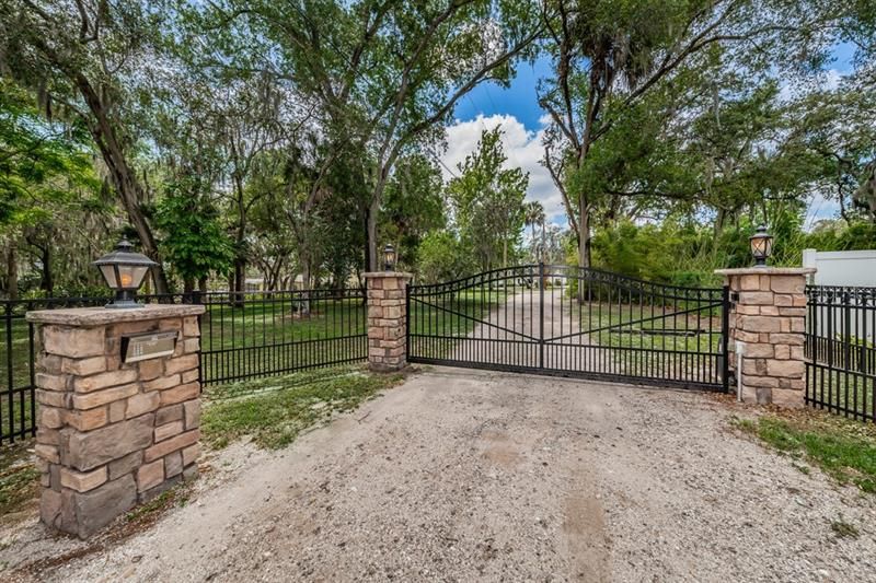 Electric Gated Entrance giving security and privacy to the 2 acres with the main house on the river and the guest house. Each home is on an acre.