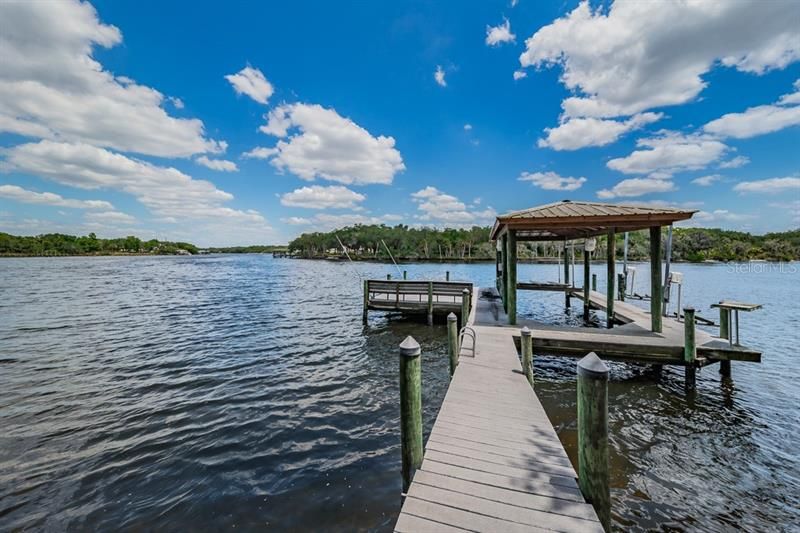 Dock & Covered Boat lift for boat and 2 jet ski lifts plus a fish cleaning table.