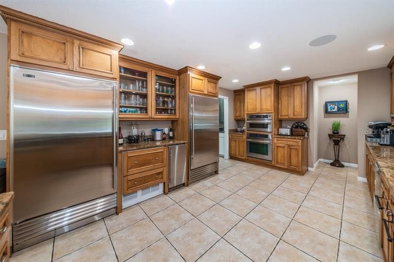 Chef's kitchen with Professional Grade appliances, Sub Zero refrigerator and freezer, 2 refrigerator drawers, ice maker, built in convection oven and microwave nestled in the beautiful wood cabinets near the huge walk  in pantry.