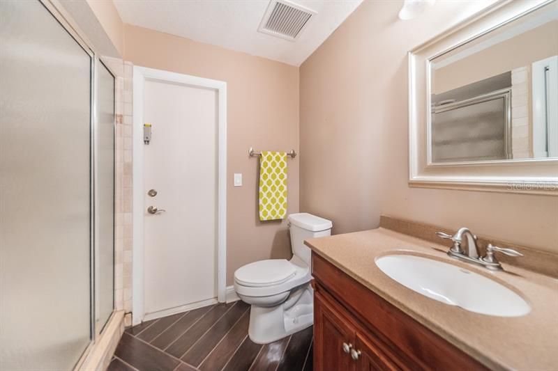 6th bathroom serves as a pool bathroom out side or a guest bathroom off the hall in the interior of the home.