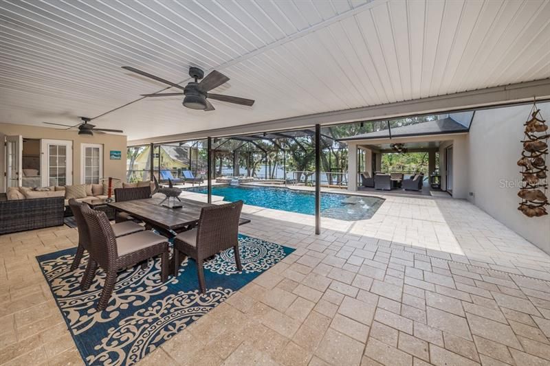 Lots of room to roam under covered or open areas of the spacious lanai and pool area viewing the back yard sanctuary.