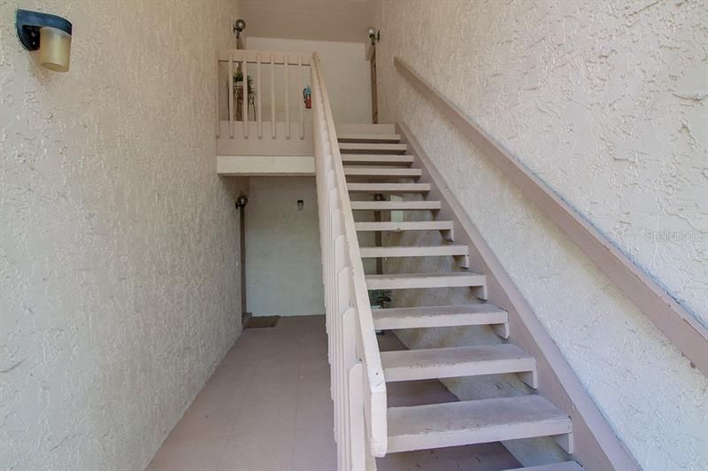Covered stairway to condo on second floor
