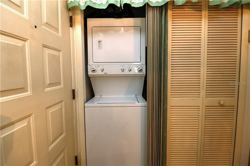 Inside laundry with stack washer & dryer too!