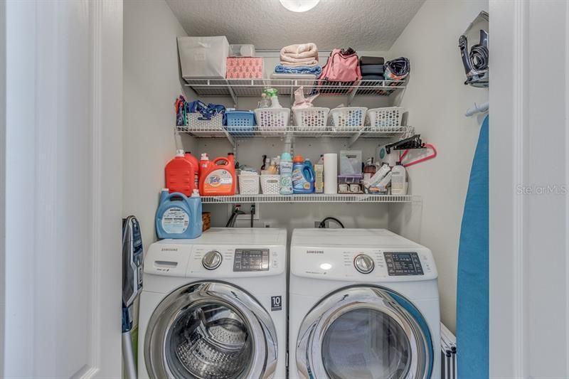 Laundry closet with built in shelving located conveniently in the hall between Master and Guest bedroom.