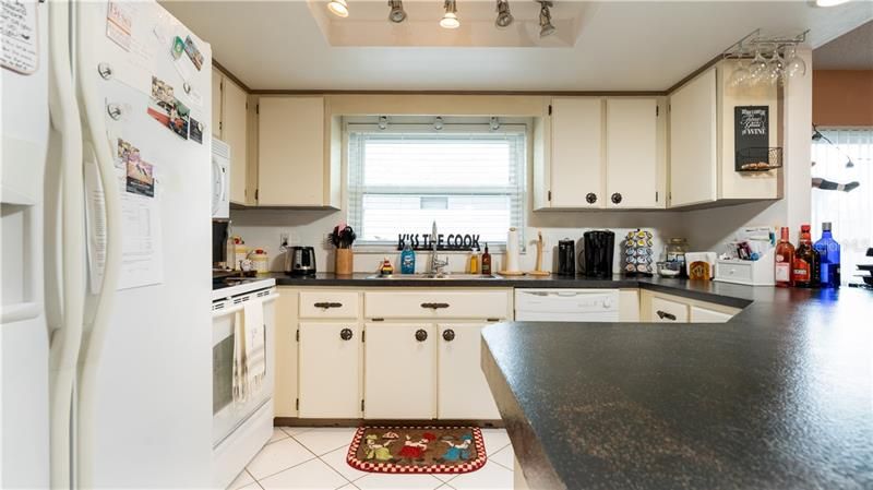 Kitchen has a huge breakfast bar, ample cabinets, and updated appliances