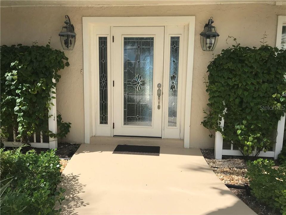 The front door is framed with beautiful bleeding heart vines.