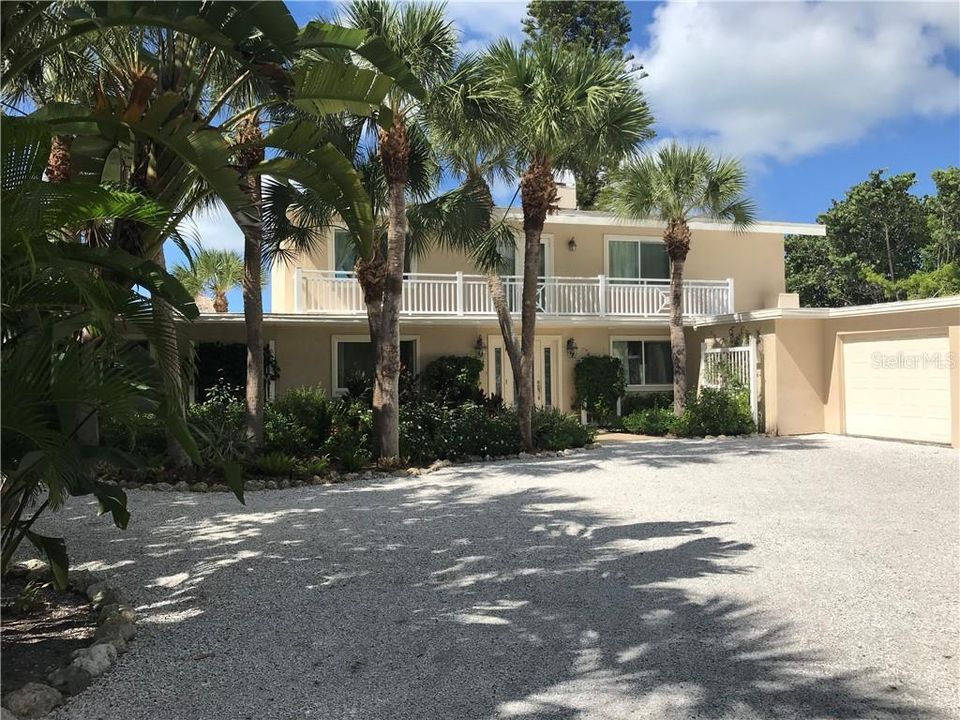 The front entrance faces east with a lovely "Florida-friendly" garden.  Landscape maintenance is included.