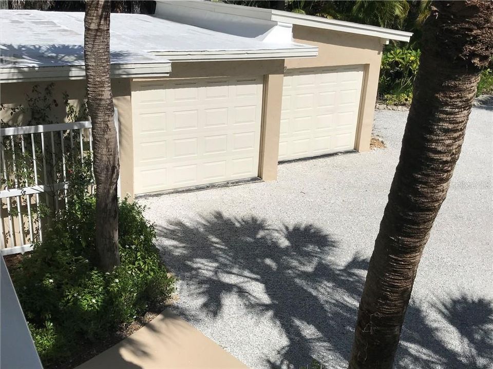 The two-car garage with a circular shell driveway.