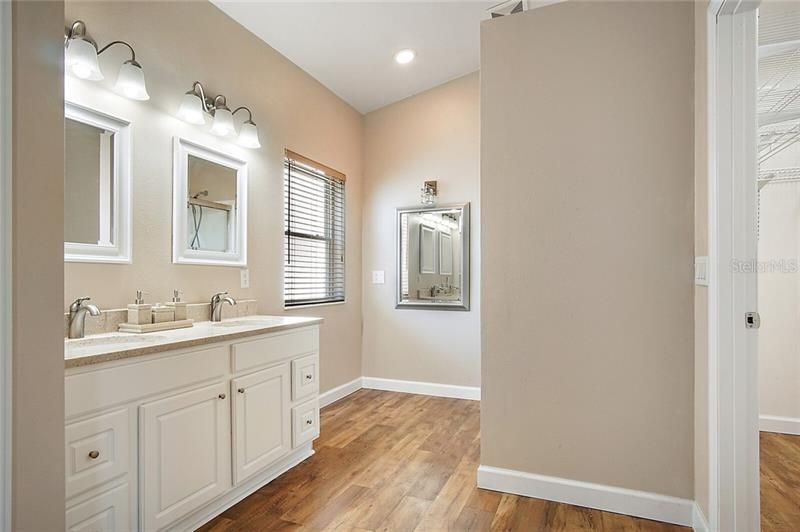 Master Bathroom with dual vanity sinks and shower