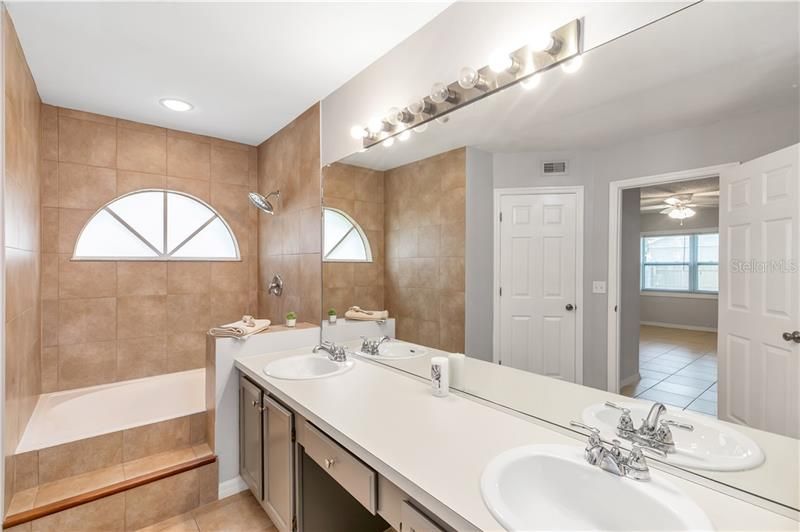 Master bathroom with dual vanities and soaking bathtub