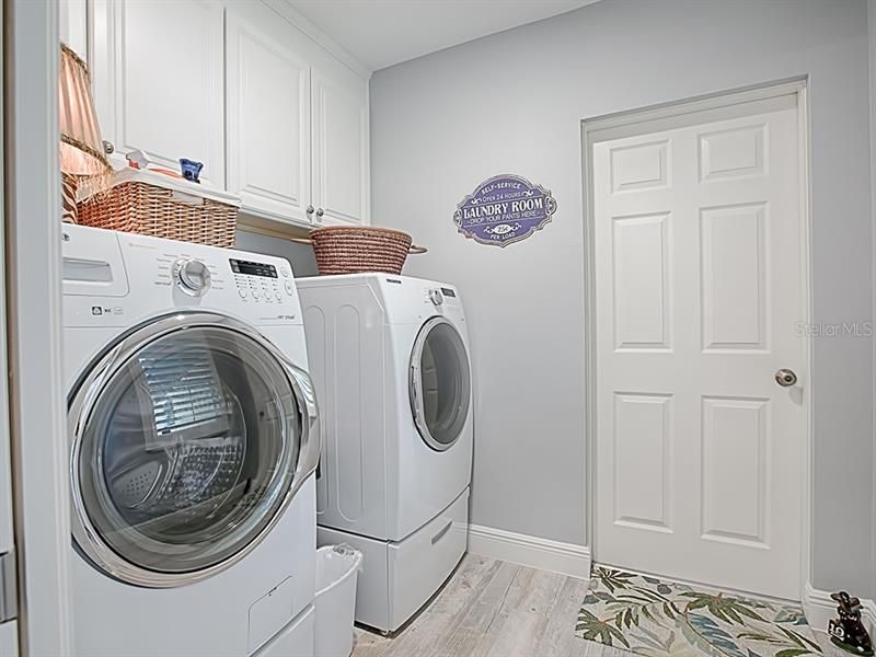 Laundry room with upgraded, front-load laundry equipment.  Door leades to the two-car garage.