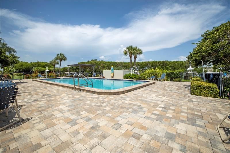 Community pool with pavers and surfboard shower