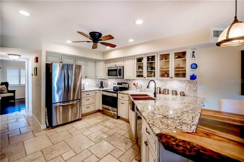 Kitchen with cream color cabinets and granite countertops