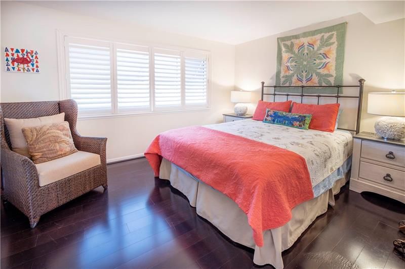 Guest bedroom with plantation shutters on impact windows