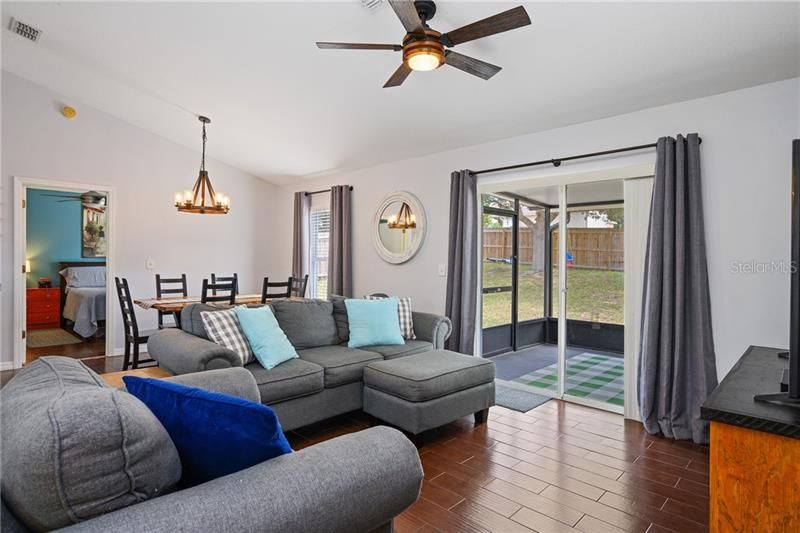 Living room with sliding doors lead out to the screened in patio