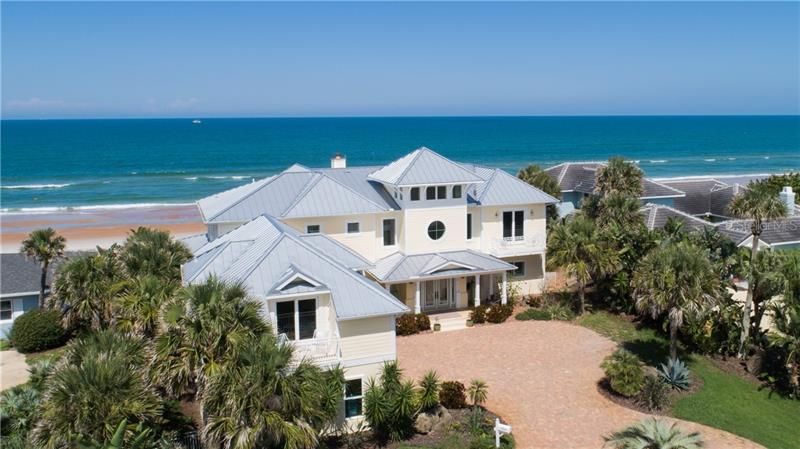 Exterior Key West architecture, spectacular ocean view,  metal roof, non drive side of Ormond Beach, 3 car detached side entry garage with apartment above.