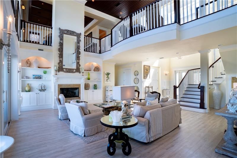 Formal Living, ocean views, loft view with dramatic espresso stained ceilings. High impact windows and sliding doors exquisite stair case, elevator access in foyer, storage under stair case.