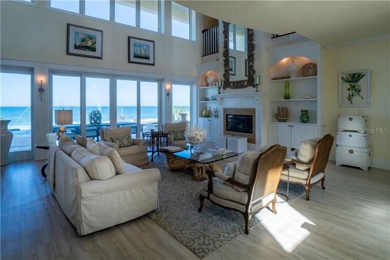 Formal Living, ocean views upper and lower windows, High impact windows and sliding doors exquisite stair case, gas fireplace with custom built in cabinets, 1/2 bath and Elevator not shown.