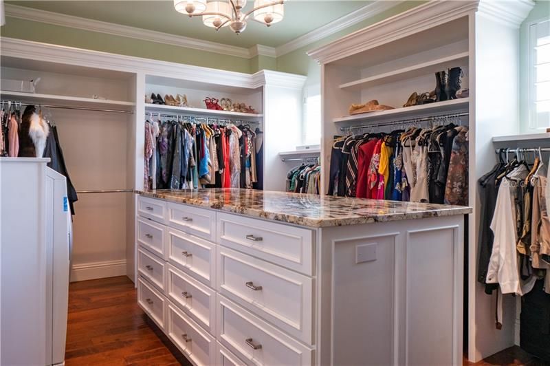 Elevator or stair access to the Master Suite.  Custom master closet built for two with private full size washer and dryer. Stone surface island ideal for folding.