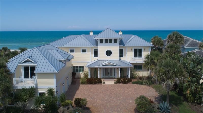 Exterior Key West architecture, spectacular ocean view,  metal roof, non drive side of Ormond Beach, 3 car detached side entry garage with apartment above private balconies view of Golf course.