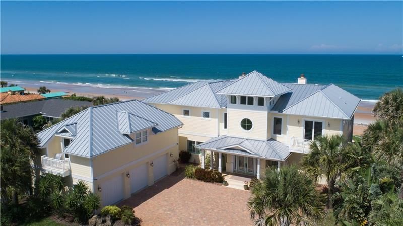 Exterior Key West architecture, metal roof, non drive side of Ormond Beach, 3 car detached side entry garage with apartment above.