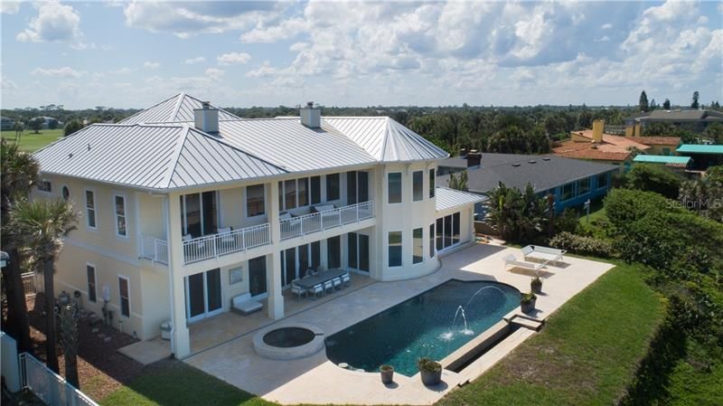 Exterior back, panoramic ocean views, upper balcony private to the master suite and the recreation room.  Lower pool side patio perfect for outdoor dining, private infinity pool, spa and oversized sun deck.