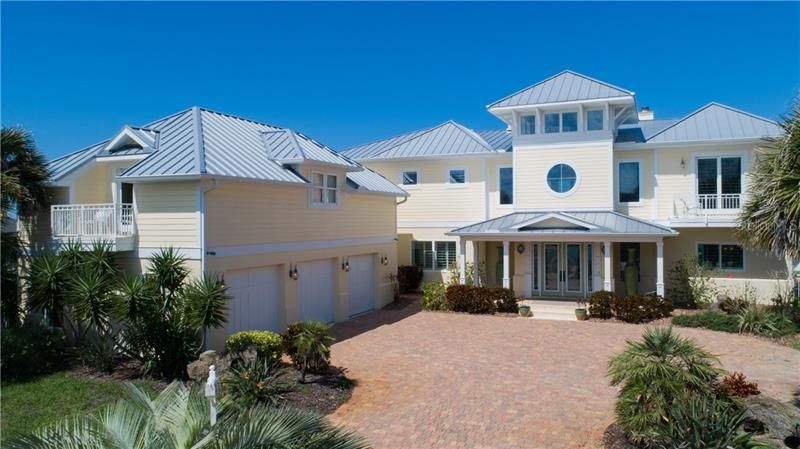 Exterior Key West architecture, spectacular ocean view,  metal roof, non drive side of Ormond Beach, 3 car detached side entry garage with apartment above, oversized driveway, front porch dramatic entrance.