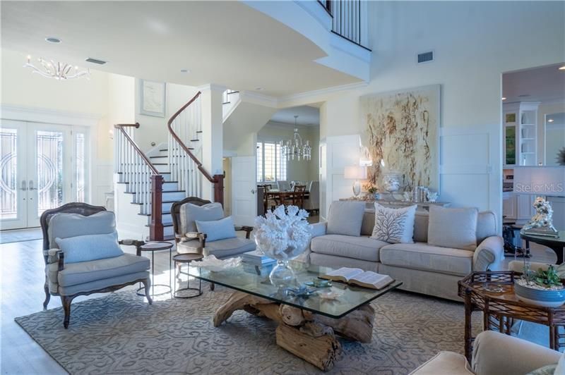 Dramatic entrance with curved banister, storage under staircase, separate formal dining with butler pantry and plantation shutters.