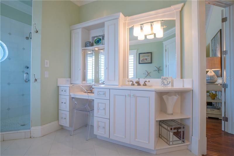 Elevator or stair access to the Master Suite.  Monotone color scheme for this sophisticate yet relaxed master spa bath, private ocean view, separate shower, water closet, dual sinks separate one with built in vanity. Opalescent sinks with light detail.