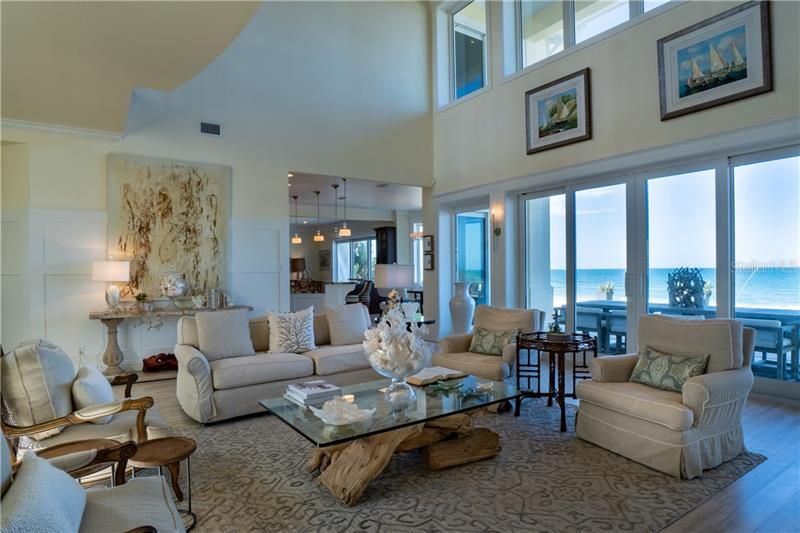 Formal Living, ocean views upper and lower windows, High impact windows and sliding doors exquisite stair case, open concept leads to the kitchen and casual family room.