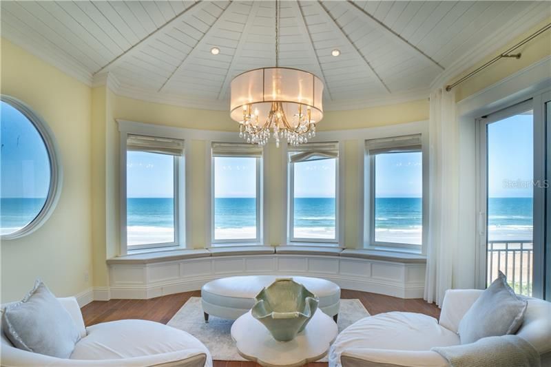 Elevator or stair access to the Master Suite.  Monotone color scheme for this sophisticate yet relaxed master suite sitting area- access to the upper outdoor balcony, window seat, radial ceiling with delicate chandelier.