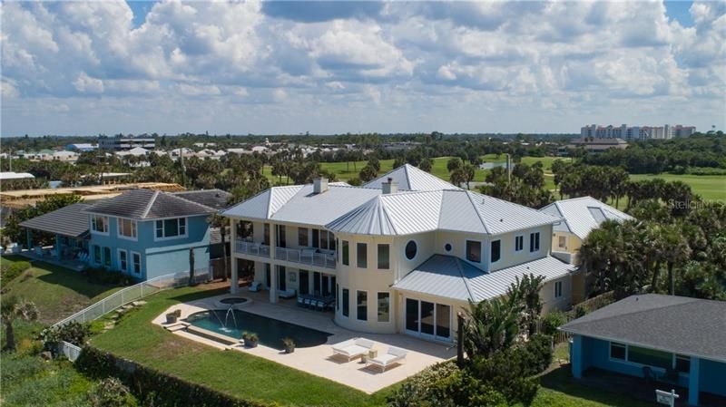 Private infinity pool with spa and sun deck. Private access to the beach at the white wrought iron fence.