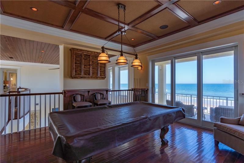 (Elevator or stair access)Upstairs loft with West indies inspired design, rich wood floors, tray ceilings, open to the downstairs below, upper balcony access with panoramic ocean view and breeze.