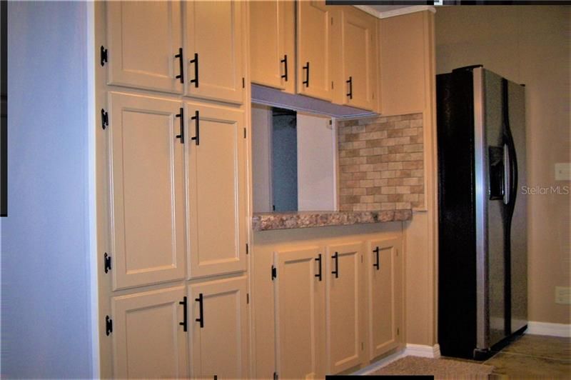 Lots of kitchen cabinet space with fridge on right