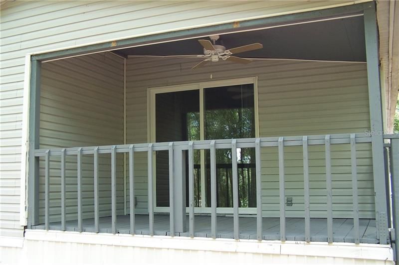 Cozy side deck /porch has electric outlets and ceiling fan