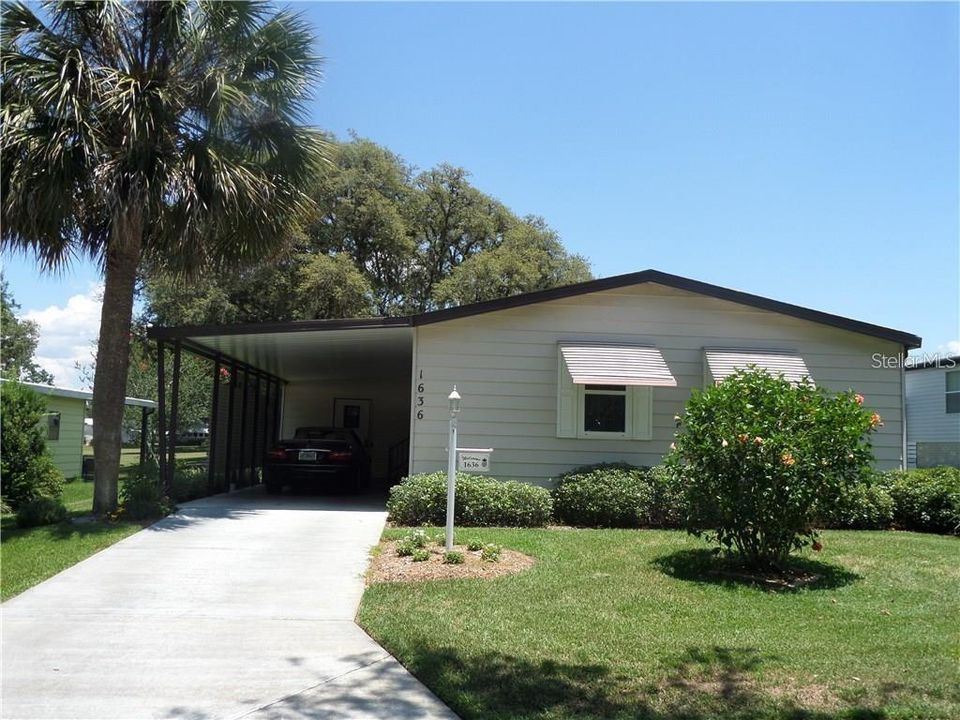 Beautiful front Elevation. Mature Landscaping with 1 car carport.