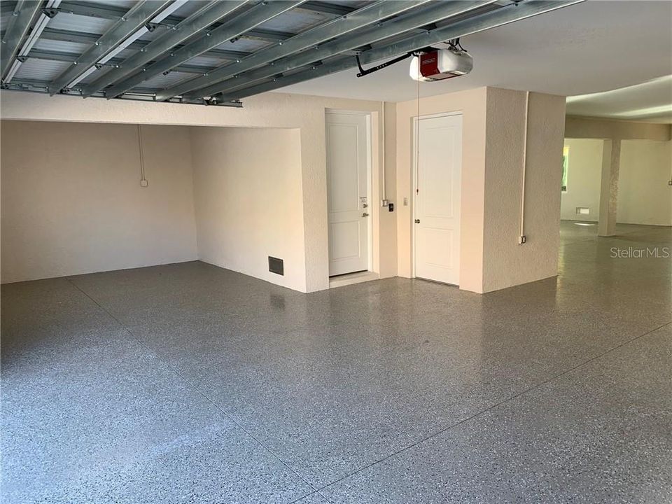 Overflow storage area in garage, ideal for a workshop area or small vehicle and watercraft parking ...entry door to home and elevator access door. Heavy duty impact garage door including opener and keypad.