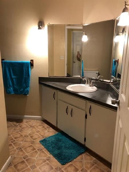 Spacious guest bath with tub & shower combo.