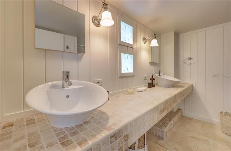 In the pool bath you will find a dual sink vanity and an upstairs bedroom for guests!