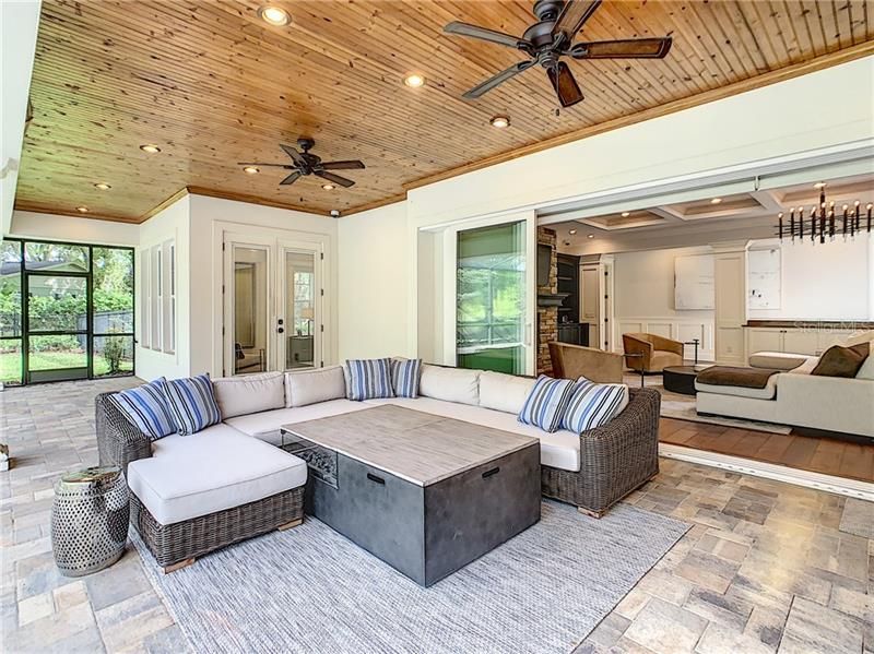 NOW WE ENTER THE OUTSIDE ENTERTAINING AREA... JUST BEAUTIFUL WITH THESE CUSTOM CEILINGS... POCKET DOORS OPEN ALL THE WAY UP TO ENJOY THE INDOOR/OUTDOOR EXPERIENCE.