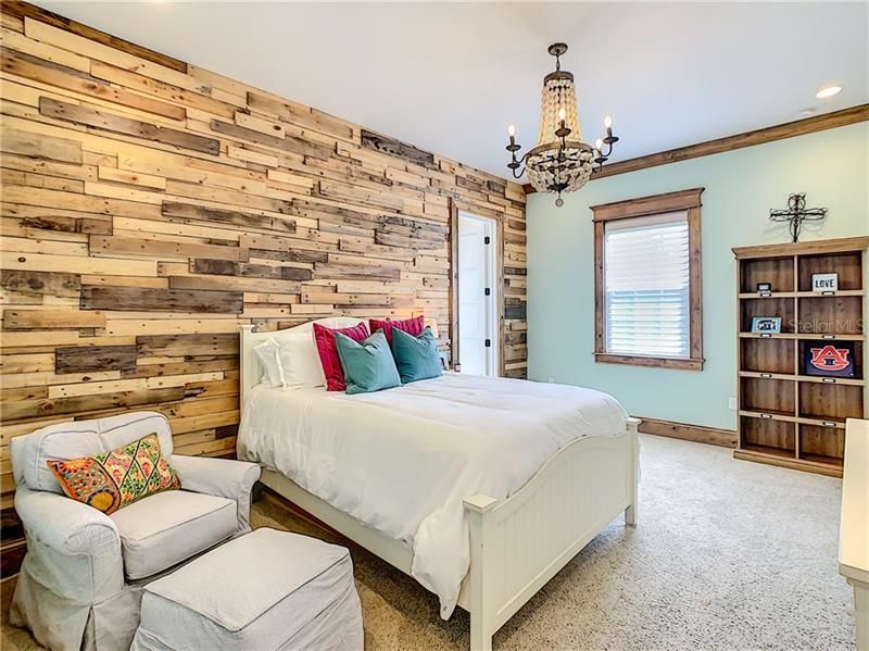 ONE OF THE THREE UPSTAIRS BEDROOMS, THESE ROOMS ARE LARGE AND ALL HAVE EN SUITE FULL BATHROOMS.  BEAUTIFUL WOODEND WALL....