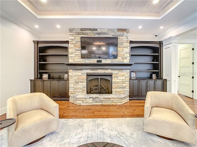ANOTHER VIEW OF THIS FABULOUS FAMILY ROOM WITH STACKED STONE GAS FIREPLACE AND CUSTOM BUILT INS.