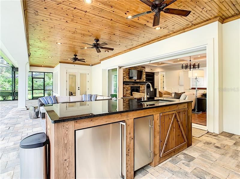 POOL AREA WITH TONS OF COUNTER SPACE, SINK, REFRIGERATOR, ICE MAKER AND SO MUCH MORE.