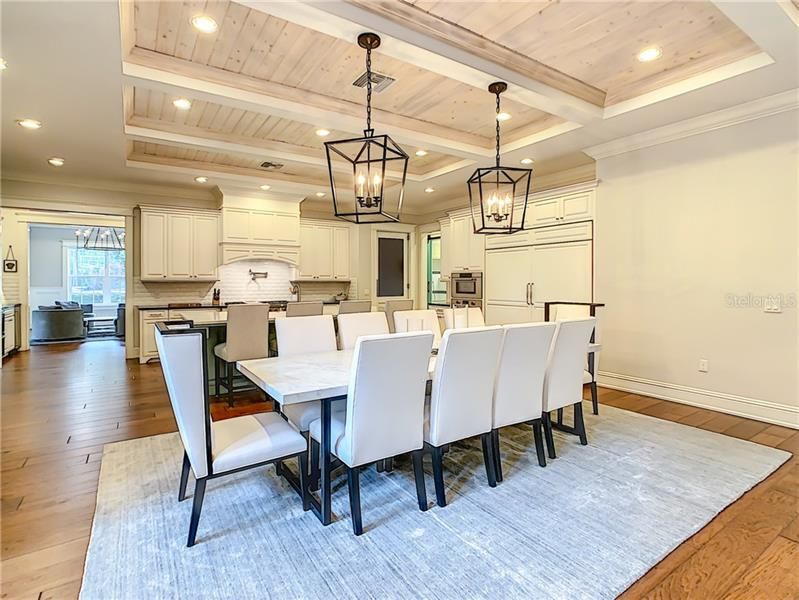 DINING ROOM AREA WITH TONGUE AND GROOVE CELINGS, OPEN FLOOR PLAN TO KITCHEN AND FAMILY ROOM