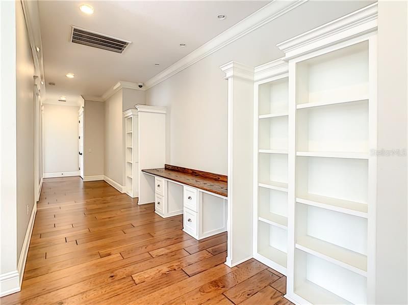 ADDITIONAL VIEW OF THE UPSTAIRS HALLWAY WITH BUILT-INS AND WORK SPACES.