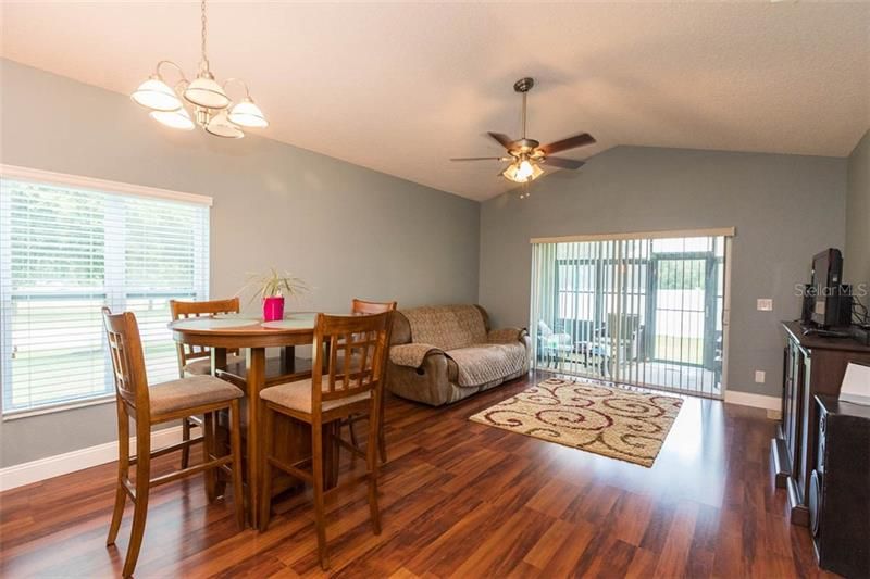 Dinette area and family room with sliding glass doors to the screended in covered lanai