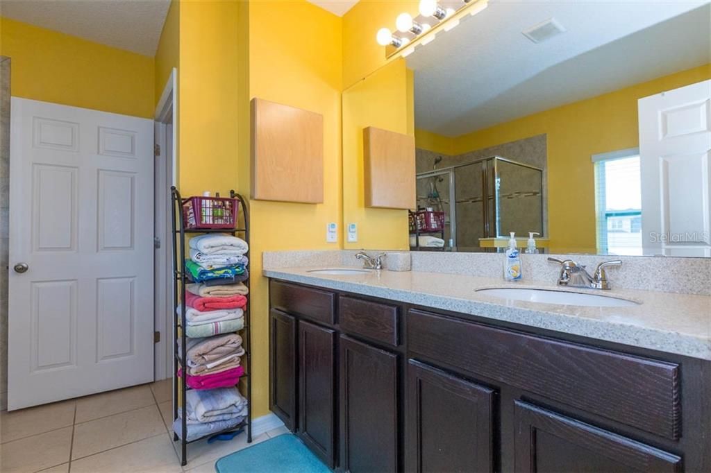 First Floor Master Bathroom with Dual Vanity Sinks and Corian countertops